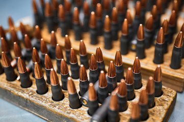 Riffle bullets in wooden racks in production plant workshop