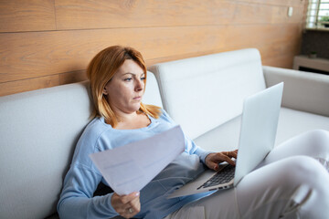 Mid adult woman going over bills at home