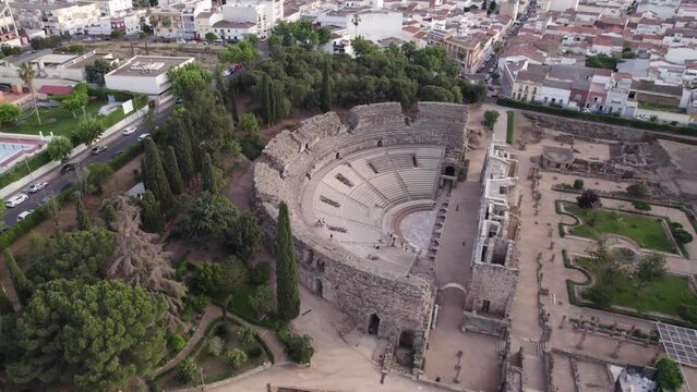 Famous roman theatre with city backdrop. Aerial wide shot. Merida, Spain