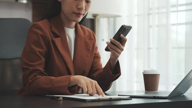 Young chinese business woman doing bookkeeping analyst audit working papers, public offering, cash budget, accrued dividend, note payable, actual cost, aging schedule, intangible fixed asset