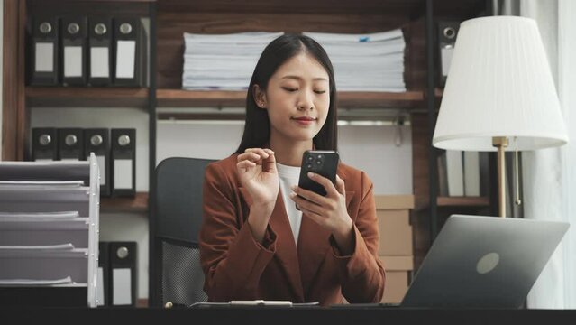 Young chinese business woman doing bookkeeping analyst audit working papers, public offering, cash budget, accrued dividend, note payable, actual cost, aging schedule, intangible fixed asset