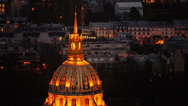 Dome des Invalides or tomb of Napoleon illuminated at night. Zoomed view