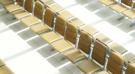 Empty yellow plastic seats near windows on airport terminal. OFFICE BACKGROUND, MODERN BUSINESS HALL WITH LIGHT REFLECTONS ON THE FLOOR,abstract blur in airport for background.