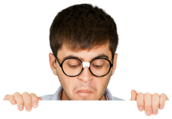 Man in taped up glasses looking down at a blank sign or board