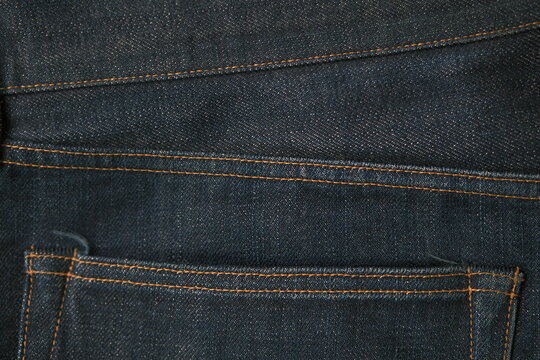 blue jeans pocket stitch texture closeup dark indigo