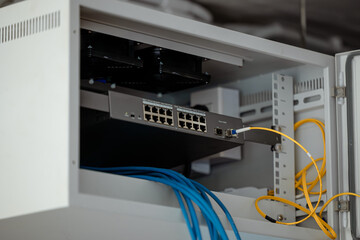 single rack LAN network switching in cabinet install internet sharing link site with Fiber optic gigabit. - obrazy, fototapety, plakaty