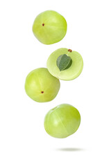 Indian gooseberry fruit (amla emblica) falling in the air isolated on white background.