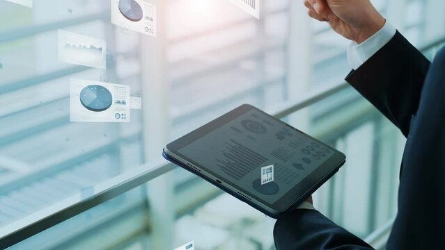 Businessman using a tablet and electronic documents concept.