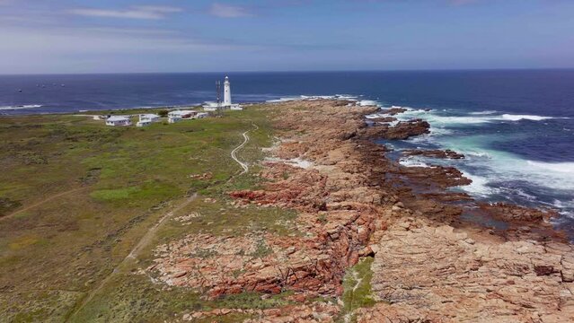 South Africa Lighthouse Cape St Francis summer Garden Route JBAY aerial drone cinematic drive from Still Bay George stunning beautiful late afternoon sunny rugged coast waves seagull birds forward