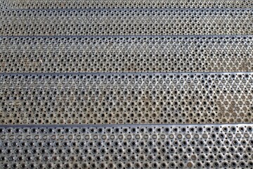 Stair steps made of perforated stainless steel. Perforated background.