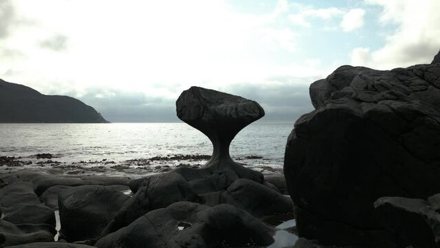 Mushroom-Shaped Rock in Norway; Kannesteinen Rock in M&aring;l&oslash;y. Far still wide shot with Overcast