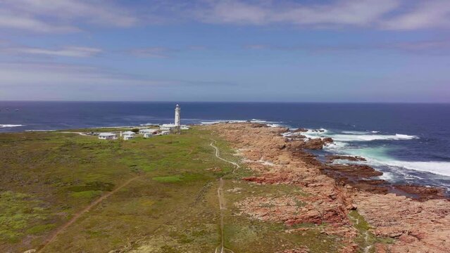 South Africa Lighthouse Cape St Francis summer Garden Route JBAY aerial drone cinematic drive from Still Bay George stunning beautiful late afternoon sunny rugged coast waves seagull birds circling