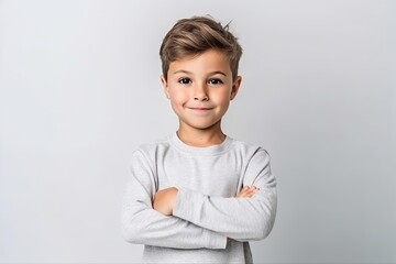 Portrait of a cute little boy in a gray sweater on a white background - obrazy, fototapety, plakaty