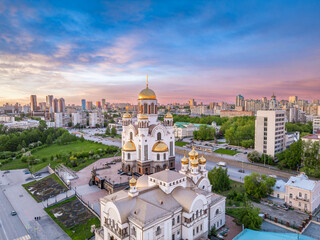 Fototapeta na wymiar Summer Yekaterinburg, Temple on Blood and Church of St Nicholas in sunset. Aerial view of Yekaterinburg, Russia. Translation of text on the temple: Honest to the Lord is the death of His saints