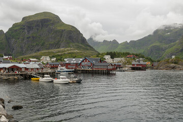 Naklejka premium Summer view during a cloudy day on the small fishing village Å i Lofoten on the Lofoten archipelago in Northern norway. Smallest village on the Lofoten islands. 14 july 2022, Å i Lofoten.