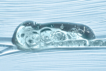 Hand sanitizer sample, liquid soap close-up on a blue background.