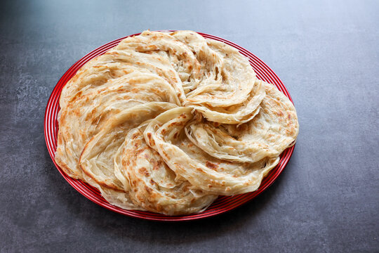 Kerala parathas / porotta / roti / parotta / barotta/ naan layered flatbread made from maida or whole wheat flour. Eat with spicy Asian chicken or beef or egg curry gravy. breakfast dish. Indian food.