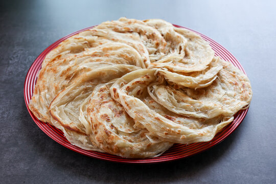 Kerala parathas / porotta / roti / parotta / barotta/ naan layered flatbread made from maida or whole wheat flour. Eat with spicy Asian chicken or beef or egg curry gravy. breakfast dish. Indian food.