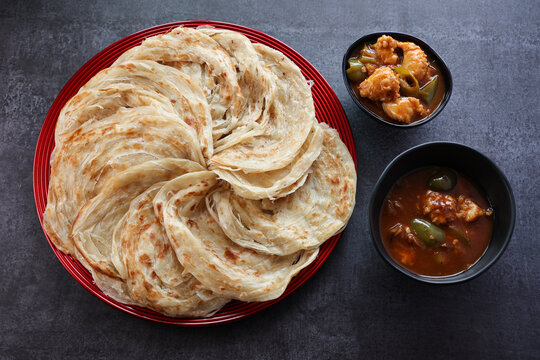 Kerala parathas / porotta / roti / parotta / barotta/ naan layered flatbread made from maida or whole wheat flour. Eat with spicy Asian chicken or beef or egg curry gravy. breakfast dish. Indian food.