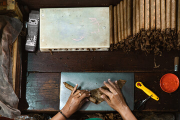top view of Cigar maker hand rolling. manual cigar spinning rolling process at a cigar factory