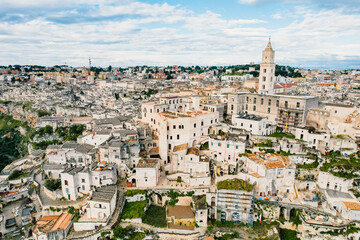 Fototapeta na wymiar Aerial view of the ancient town of Matera (Sassi di Matera) in beautiful Basilicata, southern Italy. ancient cave houses carved into the tufa rock over the deep ravine, gravina river