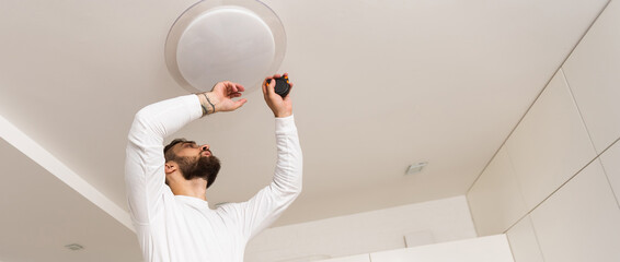 Home Ceiling Light Equipment Maintenance. Professional Electrician Worker.