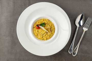 Parmesan cheese risotto on a white porcelain plate