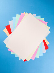 Colorful paper sheet background  isolated on blue, close up