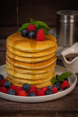 Recipe for maple syrup pancakes with raspberry and blueberry filling, High quality photo