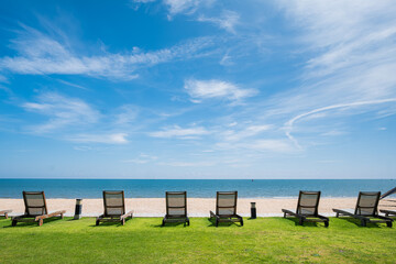 Beach chair by the sea against blue sky