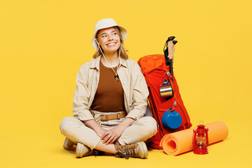 Full body happy young woman carry bag with stuff mat sit look aside on area isolated on plain...