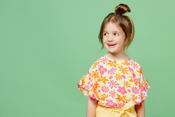 Little smiling cute kid girl 6-7 years old wear casual clothes have fun look aside on area isolated on plain pastel green background child studio portrait. Mother's Day love family lifestyle concept.