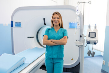 Beautiful happy female doctor physician radiologist standing in CT CAT Scan room at hospital.