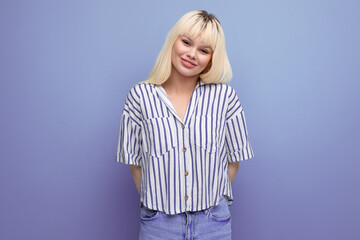 smiling blond 25 year old female person in striped blouse and jeans posing as a model