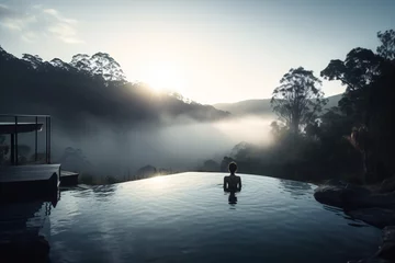 Photo sur Plexiglas Gris 2 An infinity pool in the wilderness, overlooking a forested valley and distant mountains, with an early morning fog rolling in . Generative AI. 