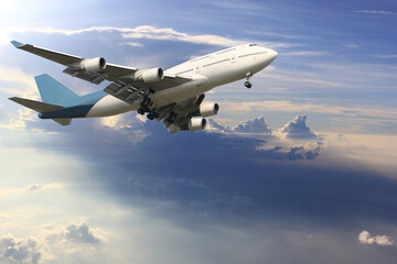 Fototapeta na wymiar Airplane is flying above the clouds on beautiful sky background,Holidays and business concept