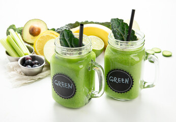 Healthy green smoothie  in a jar mug  on white background