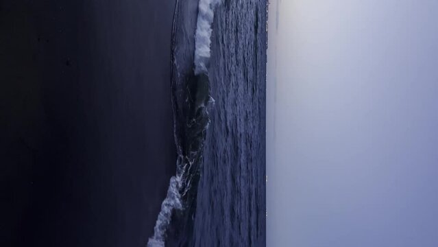 Baltic sea Dark blue clouds and sea or ocean water surface with foam waves before storm in dusk night time, dramatic seascape background. Incredible sunsets. Abstract natural pattern texture.