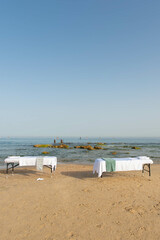 Massage table on the beach near the sea prepared by professional masseur for relax in tropical massage spa procedures.
