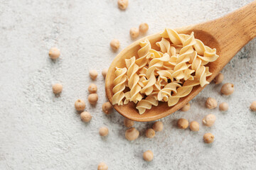 Chickpea bean fusilli pasta on a gray concrete background.