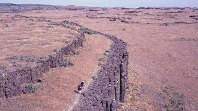 Aerial view of photographers visiting basalt rock column island in WA