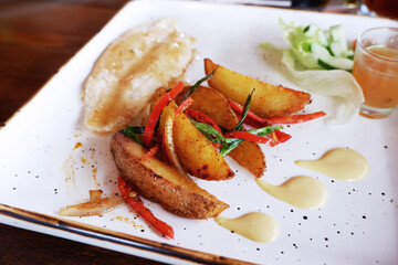 grilled dory fillet and potato wedges with lemon butter sauce