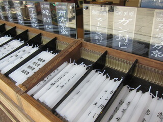 White candles in the wooden case at Kinkakuji Pagoda in Kyoto, Japan. Used for praying
