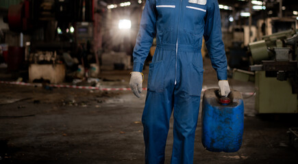 Engineer or worker industry wearing safety uniform ,white gloves under holding check chemical tank...