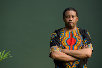 Portrait of handsome black man wearing traditional clothes with arms crossed