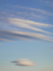 Periwinkle soft clouds in the blue sky