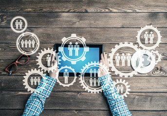Concept of teamworking and connection with gears mechanism and tablet pc