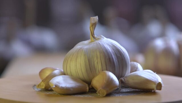 fresh garlic swirling on a wooden table