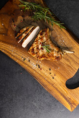 pork cutlet with a bone on rosemary and pepper