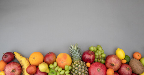 Fresh fruits on gray background